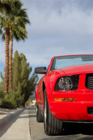 Red convertible car parked near curb Stock Photo - Premium Royalty-Free, Code: 693-03299916