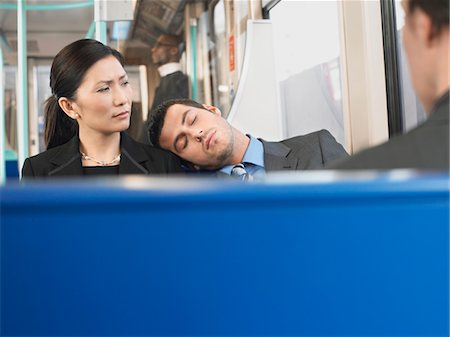 public transportation sleep - Man Sleeping on Businesswoman's Shoulder on Train Stock Photo - Premium Royalty-Free, Code: 693-03304109