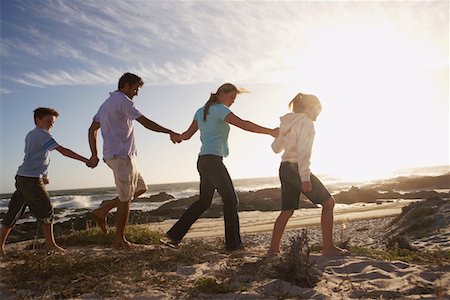Parents and children walking hand in hand, on seashore, side view Stock Photo - Premium Royalty-Free, Code: 693-03304287