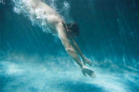 profile of person diving into pool - Semi-dressed man swimming, side view, underwater view Stock Photo - Premium Royalty-Free, Code: 693-03304374