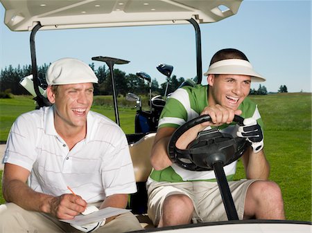 sun visor hat - Two young male golfers sitting in cart, laughing Stock Photo - Premium Royalty-Free, Code: 693-03304437