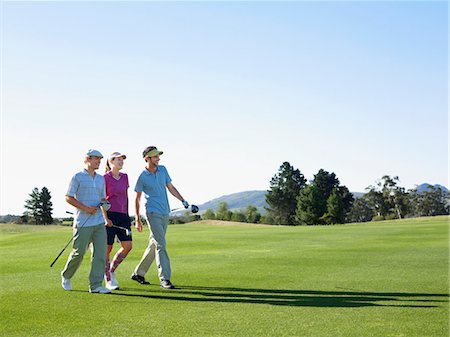 sun visor hat - Three young golfers on course Stock Photo - Premium Royalty-Free, Code: 693-03304447