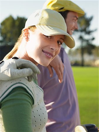 simsearch:693-06668077,k - Two young golfers on court, focus on woman Fotografie stock - Premium Royalty-Free, Codice: 693-03304454