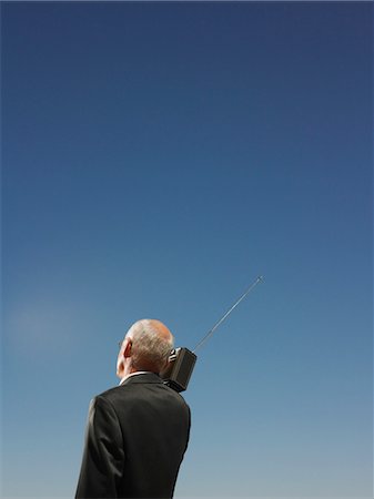 executive man hot - Businessman Under Clear Sky Listening to Radio Stock Photo - Premium Royalty-Free, Code: 693-03304496