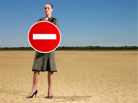 simsearch:693-03304499,k - Businesswoman holding 'no entry' sign in desert, full length Stock Photo - Premium Royalty-Free, Code: 693-03304501