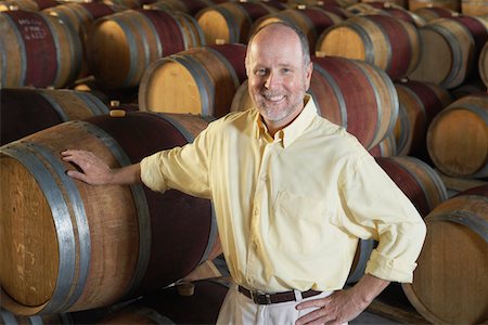 Man leaning on wine casks Stock Photo - Premium Royalty-Free, Code: 693-03304565