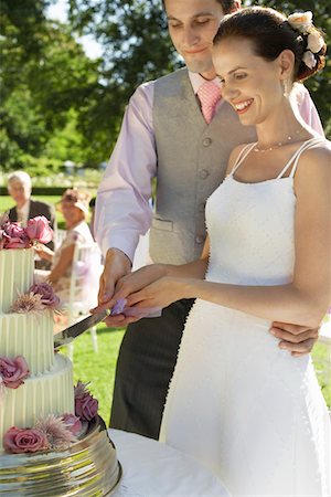 someone cutting cake - Mid adult bride and groom cutting wedding cake, smiling Stock Photo - Premium Royalty-Free, Code: 693-03304886