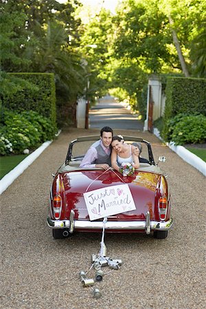 Portrait of newlyweds in vintage convertible Stock Photo - Premium Royalty-Free, Code: 693-03304892