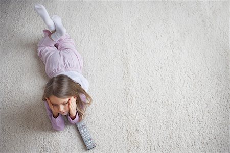 Girl (5-6) lying on rug, view from above Stock Photo - Premium Royalty-Free, Code: 693-03305078