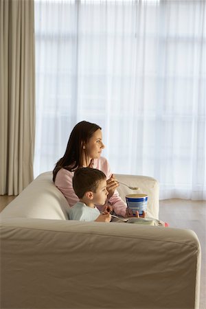 eating ice cream on couch - Mother With Son Eating Ice Cream in Living Room Stock Photo - Premium Royalty-Free, Code: 693-03305098