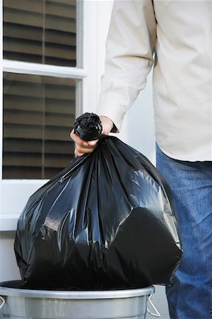 rubbish bag - Man putting garbage bag into trash can, mid section Stock Photo - Premium Royalty-Free, Code: 693-03305213