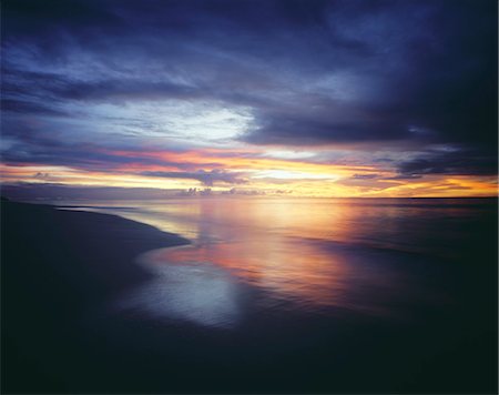 paradise scene - Sunset and Overcast Sky Over Beach Stock Photo - Premium Royalty-Free, Code: 693-03305255