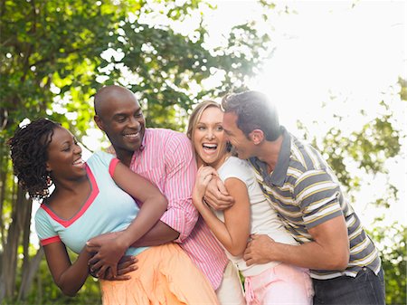 Two couples laughing in garden Stock Photo - Premium Royalty-Free, Code: 693-03305392