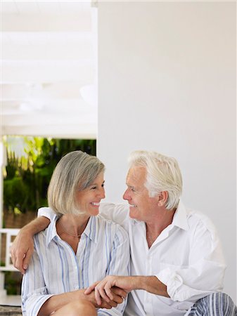 simsearch:693-03305464,k - Senior couple sitting on verandah, looking in eyes and smiling Stock Photo - Premium Royalty-Free, Code: 693-03305403