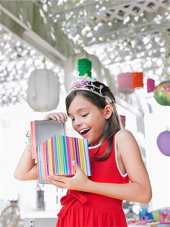 shocked tween girls - Young girl (7-9) opening birthday present at party Stock Photo - Premium Royalty-Free, Code: 693-03305601