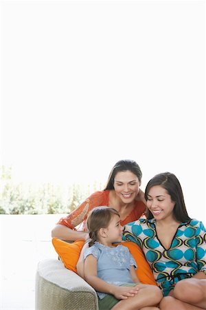 parent talking to their 16 year old - Mid-adult woman, teenage girl (16-18) and girl (5-6) relaxing on sofa Stock Photo - Premium Royalty-Free, Code: 693-03305729