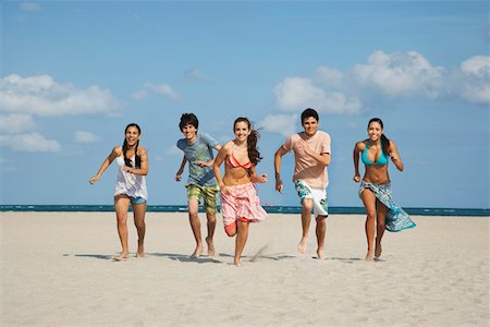running teenage boy & girl - Group of teenagers (16-17) running on beach Stock Photo - Premium Royalty-Free, Code: 693-03305813