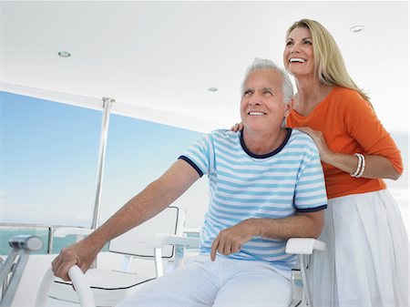fair haired mature male boat - Smiling middle-aged couple at helm of yacht Stock Photo - Premium Royalty-Free, Code: 693-03305863
