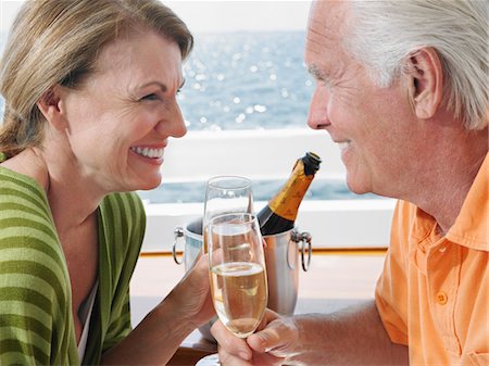 Middle-aged couple drinking champagne on yacht, side view, close-up Stock Photo - Premium Royalty-Free, Code: 693-03305889