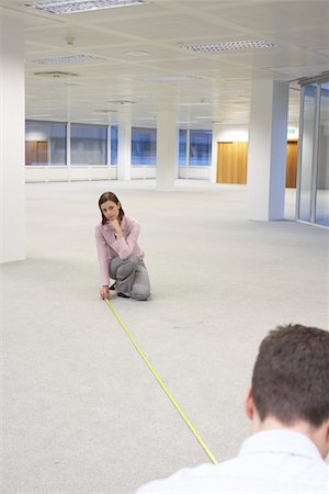 Man and Woman Measuring New Office Space Stock Photo - Premium Royalty-Free, Code: 693-03306043