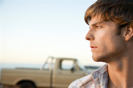 Young man, head and shoulders, profile, in front of van Stock Photo - Premium Royalty-Free, Code: 693-03306151