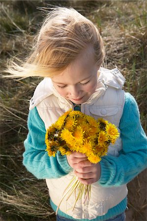 Girl (5-6) holding bunch of flowers, outdoors Stock Photo - Premium Royalty-Free, Code: 693-03306642