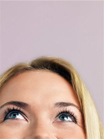 Mid adult woman looking up, high section, high section, close-up Stock Photo - Premium Royalty-Free, Code: 693-03306786
