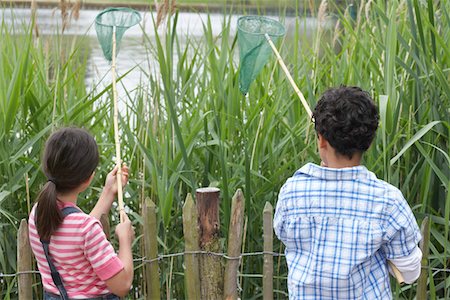 simsearch:693-03309308,k - Brother and sister (5-9) with fishing nets at lake Stock Photo - Premium Royalty-Free, Code: 693-03306948