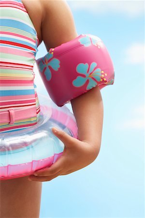 preteen one piece swimsuit - Girl (7-9 years) wearing inflatable ring and water wings, mid section Stock Photo - Premium Royalty-Free, Code: 693-03307029