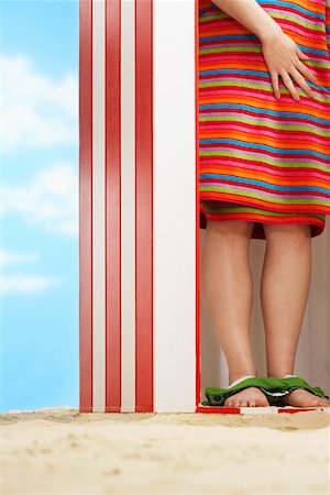 Woman standing in beach change cabin, low section Stock Photo - Premium Royalty-Free, Code: 693-03307032