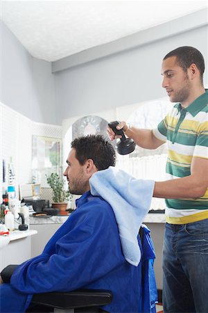 Barber preparing man for haircut in barber shop Stock Photo - Premium Royalty-Free, Code: 693-03307117