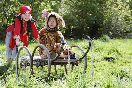 simsearch:693-03309303,k - Portrait of boy (7-9) wearing pirate costume pushing boy (5-6) in cart in jaguar costume, garden Stock Photo - Premium Royalty-Free, Code: 693-03307178