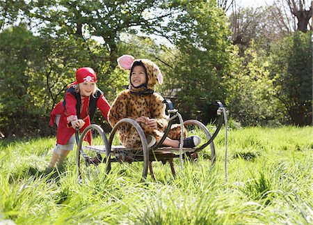 simsearch:693-03309303,k - Young boy (7-9) in pirate costume pushing boy (5-6) in cart in jaguar costume, smiling Stock Photo - Premium Royalty-Free, Code: 693-03307179