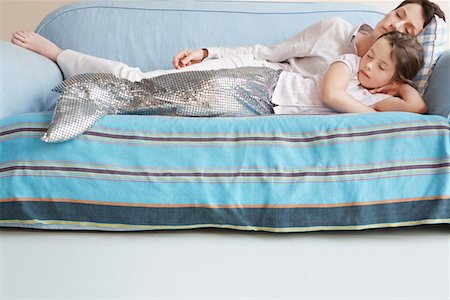 sirena - Young girl (5-6) wearing mermaid costume sleeping on sofa with mother Fotografie stock - Premium Royalty-Free, Codice: 693-03307192