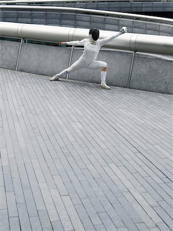 fencing mask - Female fencer lunging, outdoors Stock Photo - Premium Royalty-Free, Code: 693-03307315