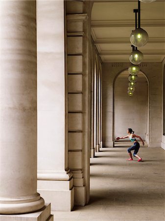 discus throwing - Female athlete throwing discus in portico, side view Stock Photo - Premium Royalty-Free, Code: 693-03307317