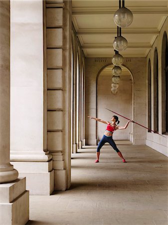 Female athlete throwing javelin in portico Stock Photo - Premium Royalty-Free, Code: 693-03307319