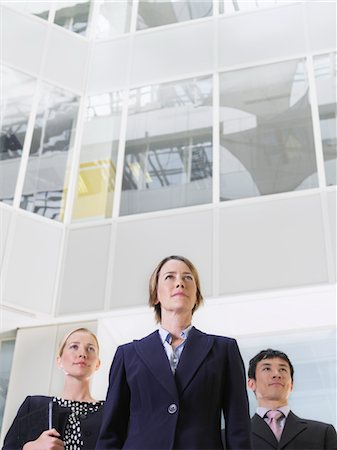 simsearch:693-03311509,k - Three business people standing in atrium of office building, low angle view Stock Photo - Premium Royalty-Free, Code: 693-03307376