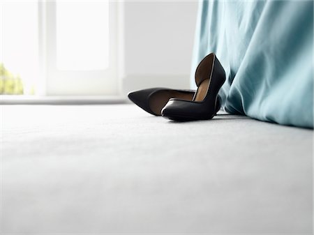 High heeled shoes by bed, surface view Stock Photo - Premium Royalty-Free, Code: 693-03307417