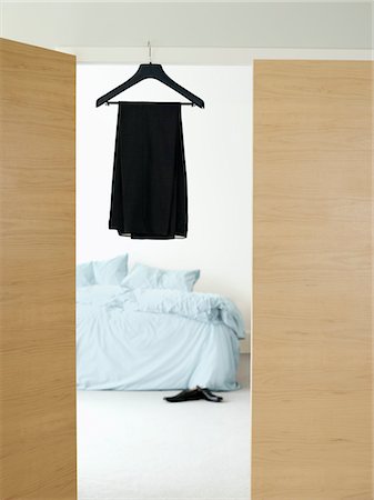 Dress on hanger in doorway of bedroom Stock Photo - Premium Royalty-Free, Code: 693-03307418