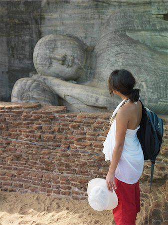 simsearch:693-03307574,k - Young woman looking at statue of sleeping Buddha, side view Stock Photo - Premium Royalty-Free, Code: 693-03307556