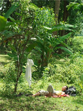 simsearch:693-03307574,k - Yung woman lying in tropical forest, sunbathing Stock Photo - Premium Royalty-Free, Code: 693-03307570