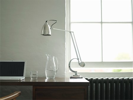 radiator - Desk with laptop, lamp and jug of water Stock Photo - Premium Royalty-Free, Code: 693-03307601