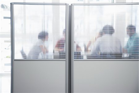 Office workers meeting behind cubicle wall in office Stock Photo - Premium Royalty-Free, Code: 693-03307915