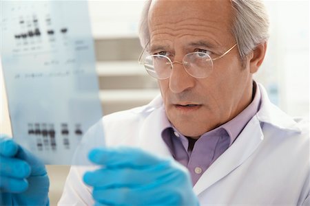dna results - Scientist looking at DNA test results indoors Stock Photo - Premium Royalty-Free, Code: 693-03307998