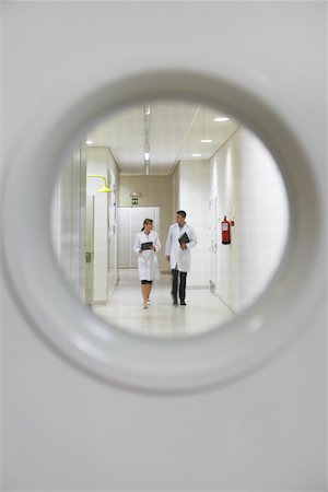 physicians walking front view - Two scientists walking down hallway, view from window in door Stock Photo - Premium Royalty-Free, Code: 693-03308051