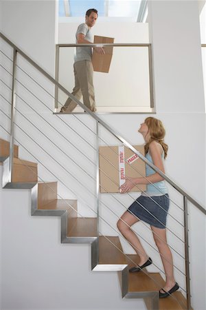 Couple carrying boxes upstairs in new home Stock Photo - Premium Royalty-Free, Code: 693-03308296