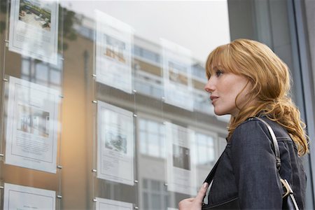female real estate agent - Woman looking in window outside estate agents Stock Photo - Premium Royalty-Free, Code: 693-03308314