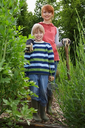 rain boots and child and mom - Mother standing with son (5-6) in garden, portrait Stock Photo - Premium Royalty-Free, Code: 693-03308363