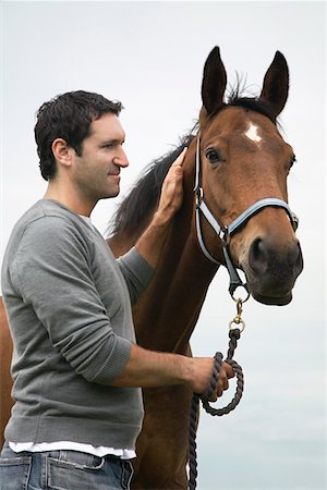 Man with horse, outdoors Stock Photo - Premium Royalty-Free, Code: 693-03308406